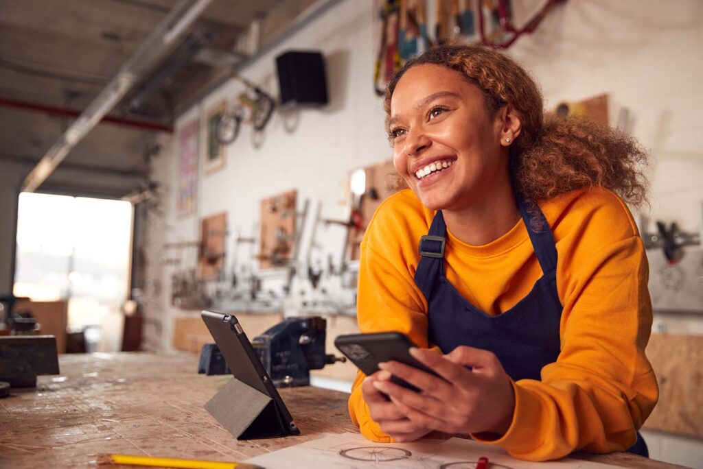 Happy Black Female Business Owner in Her Own Bicycle Shop